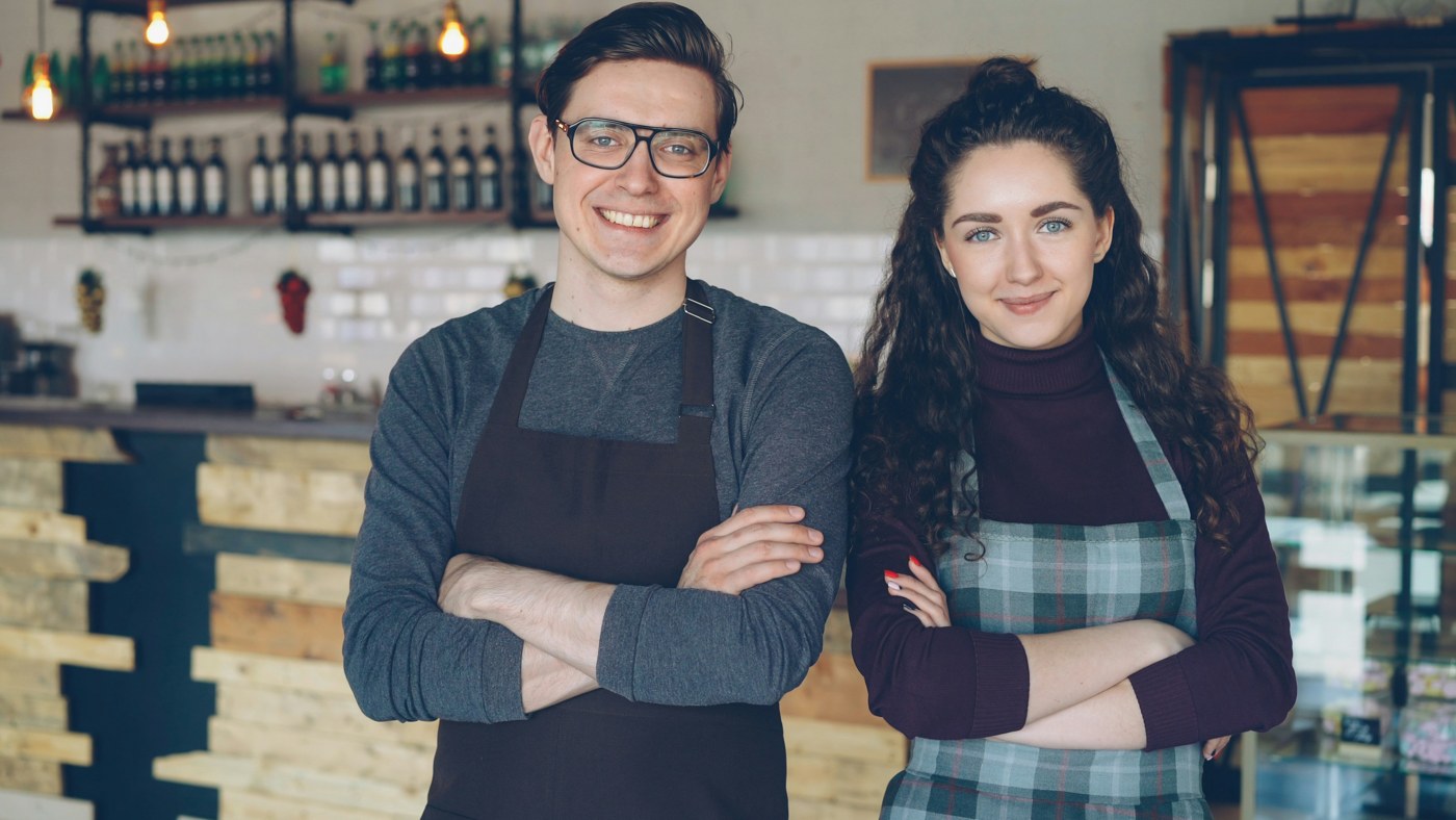 Two cafe owners standing together